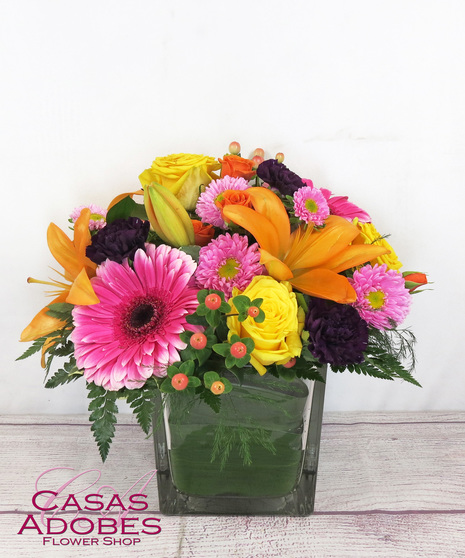 Bright Spring Flowers in a Cube Vase with roses, lily, asters, gerbera daisies and solid aster