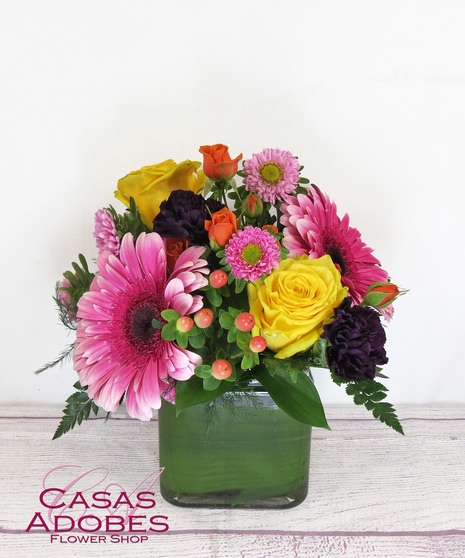 Bright Spring Flowers in a Cube Vase with roses, lily, asters, gerbera daisies and solid aster