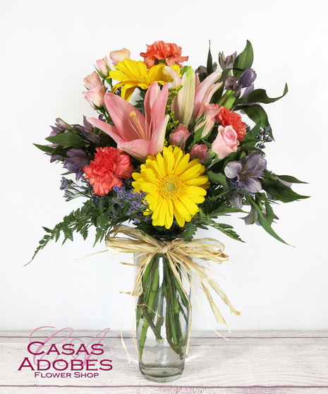 Vase of spring flowers with gerbera daisies, lily, alstroemeria, mini carnations and solid aster